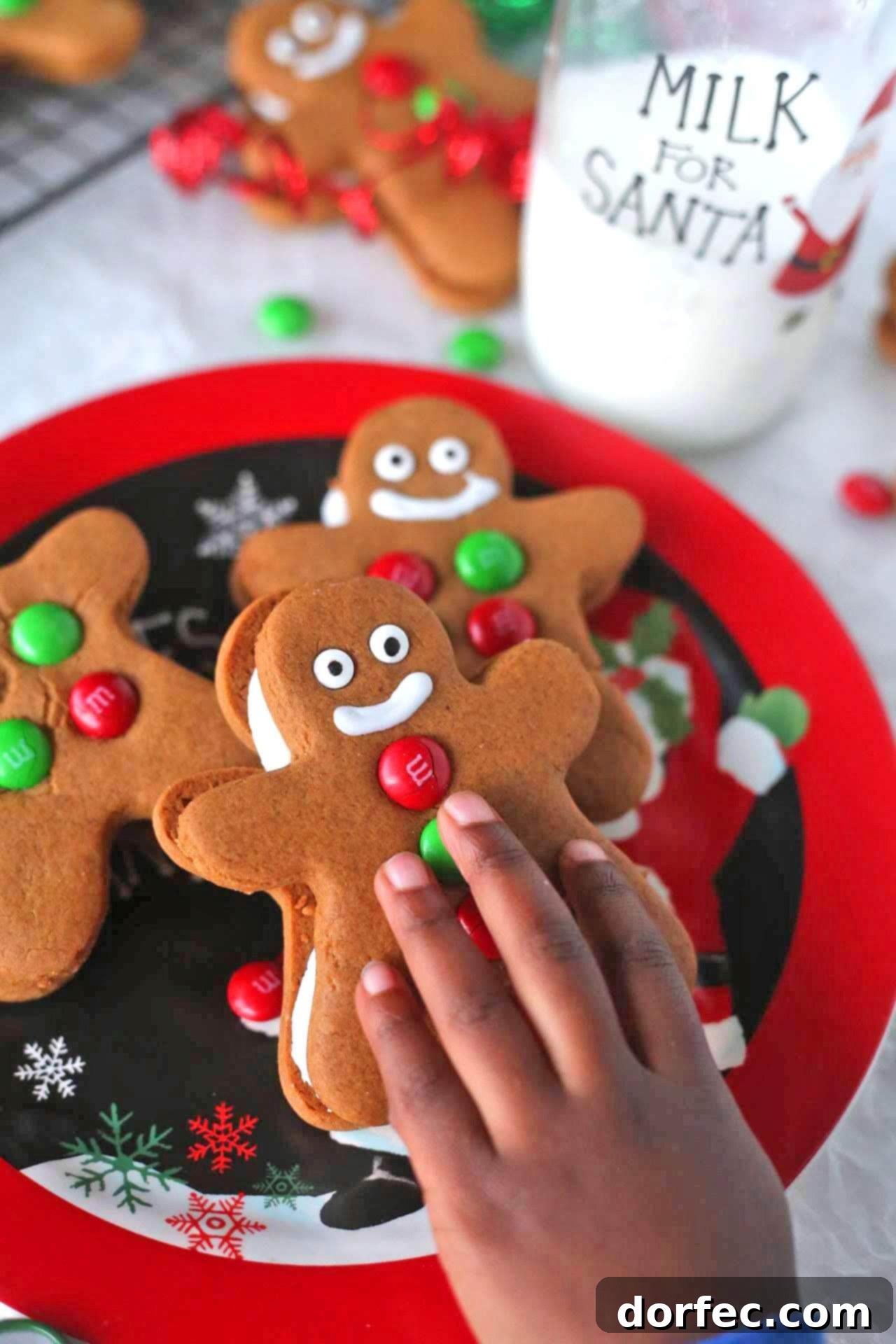 Close-up of a stack of Gingerbread Men Sandwich Cookies with creamy filling, highlighting their soft texture and delightful design.