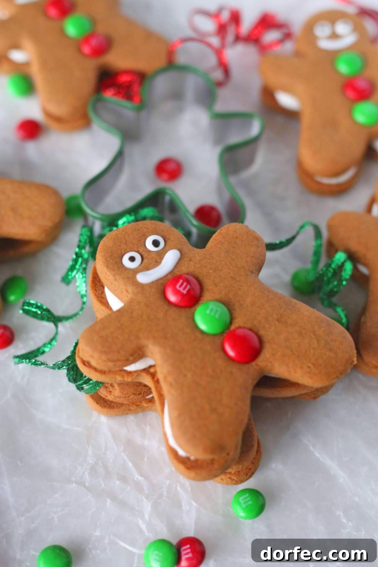 Freshly baked Gingerbread Men Cookies cooling on a wire rack after being removed from the oven, ready for the creamy filling.