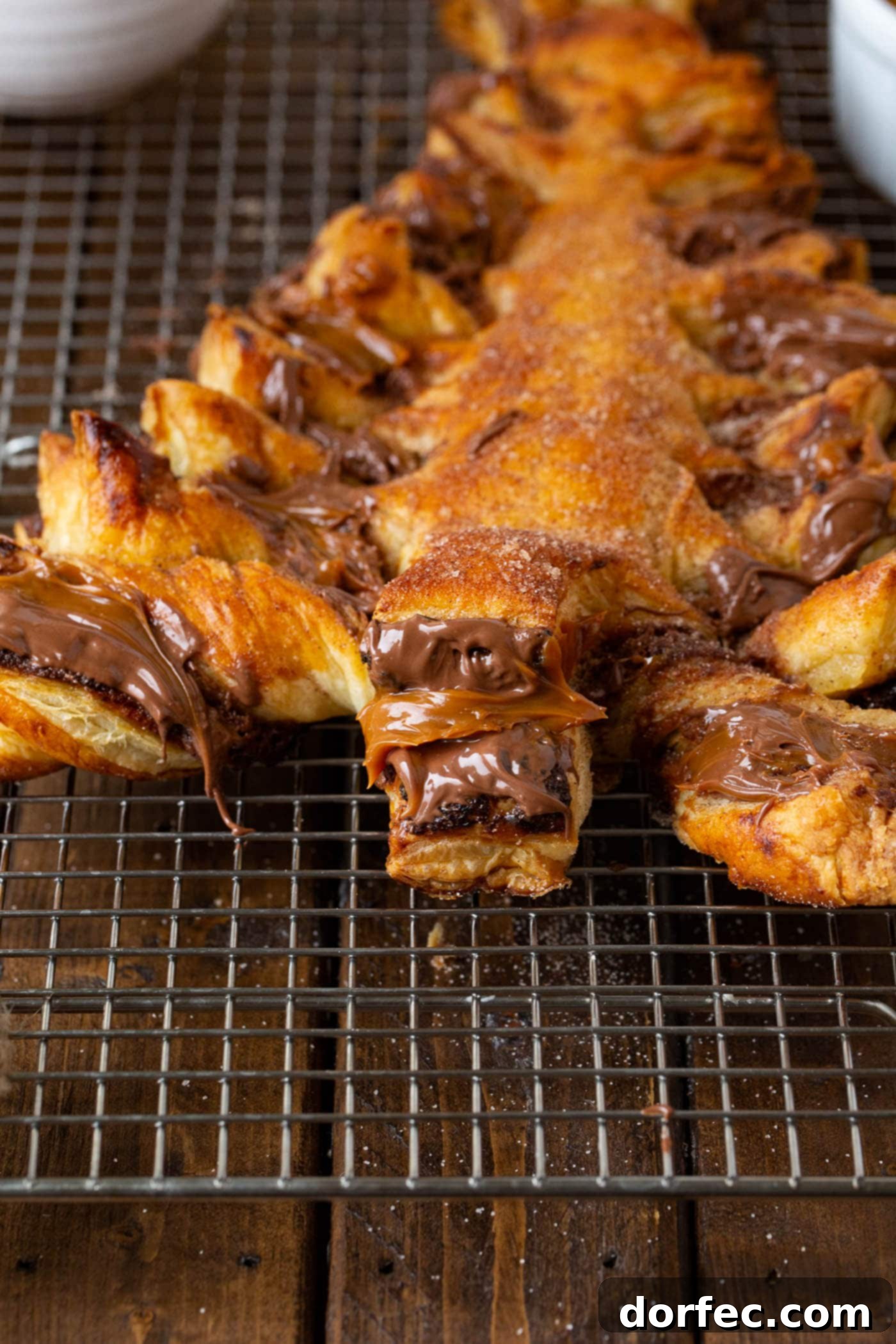 Nutella Dulce de Leche Christmas Tree A photo of perfectly baked golden Nutella dulce de leche Christmas tree sitting on a cooling rack.