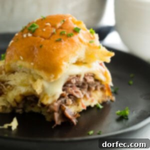 A beautifully composed image of French Dip Sliders, showing their golden buns and savory fillings.
