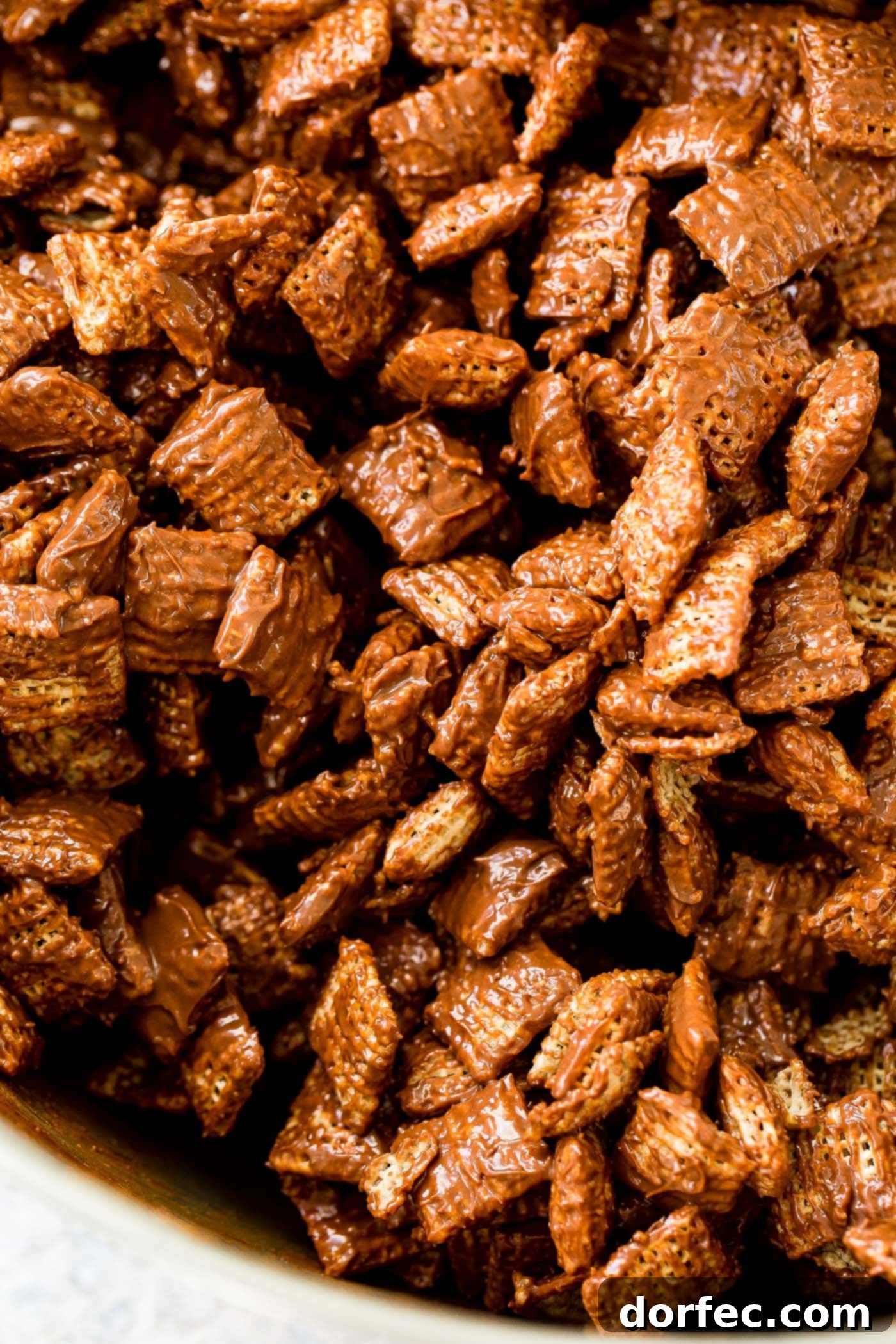 A photo of rice Chex coated in melted chocolate and peanut butter.