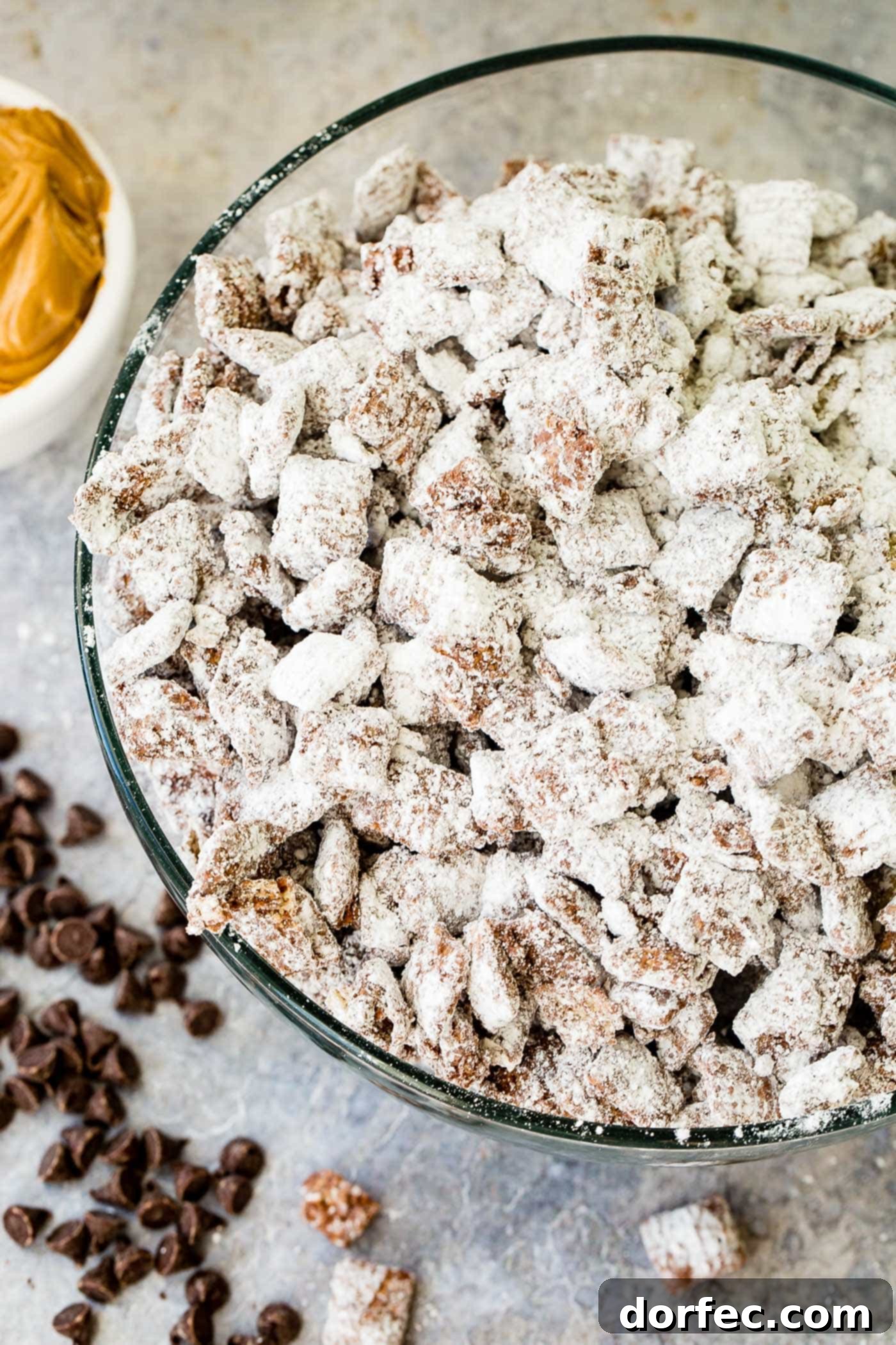 A photo of muddy buddies snack mix in a glass bowl.