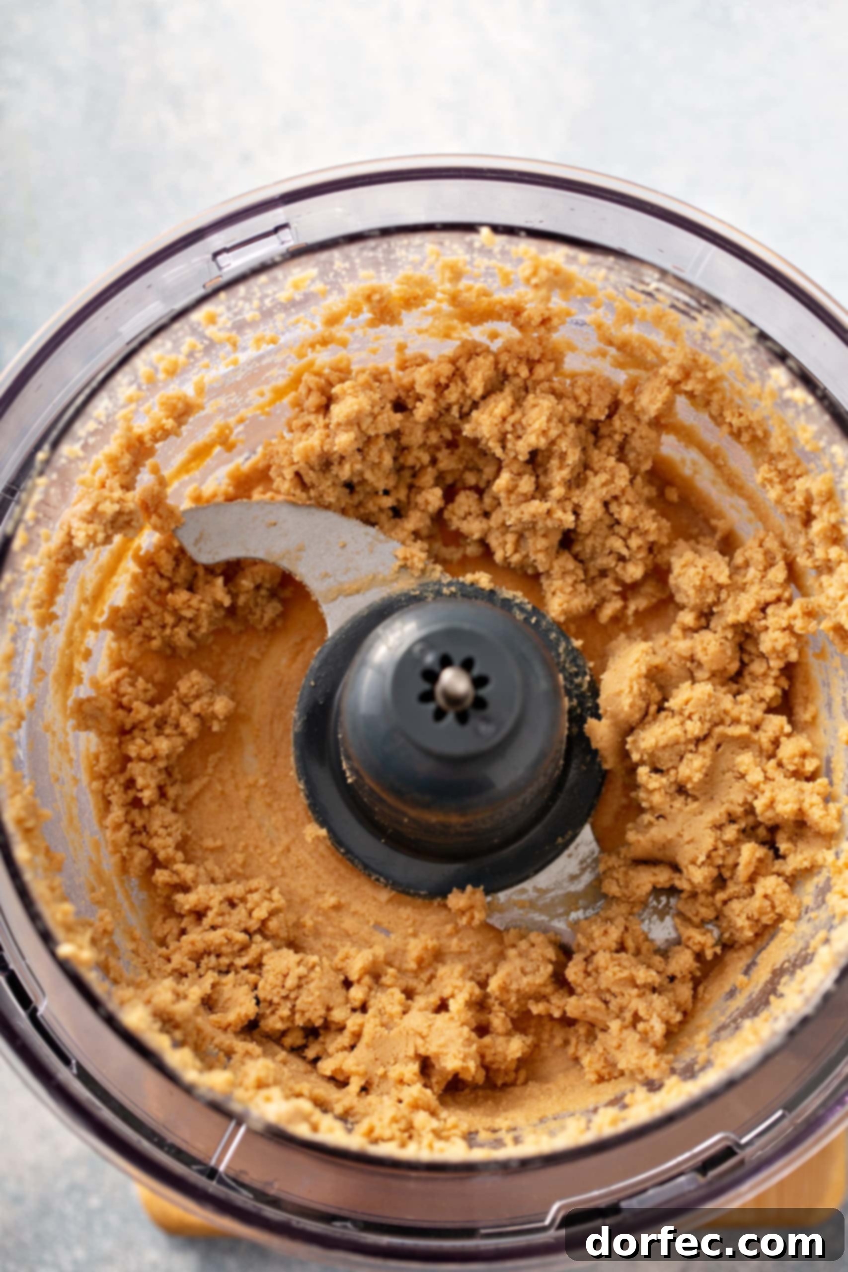Best Easy Homemade Hummus A food processor with partially blended chick peas for hummus.