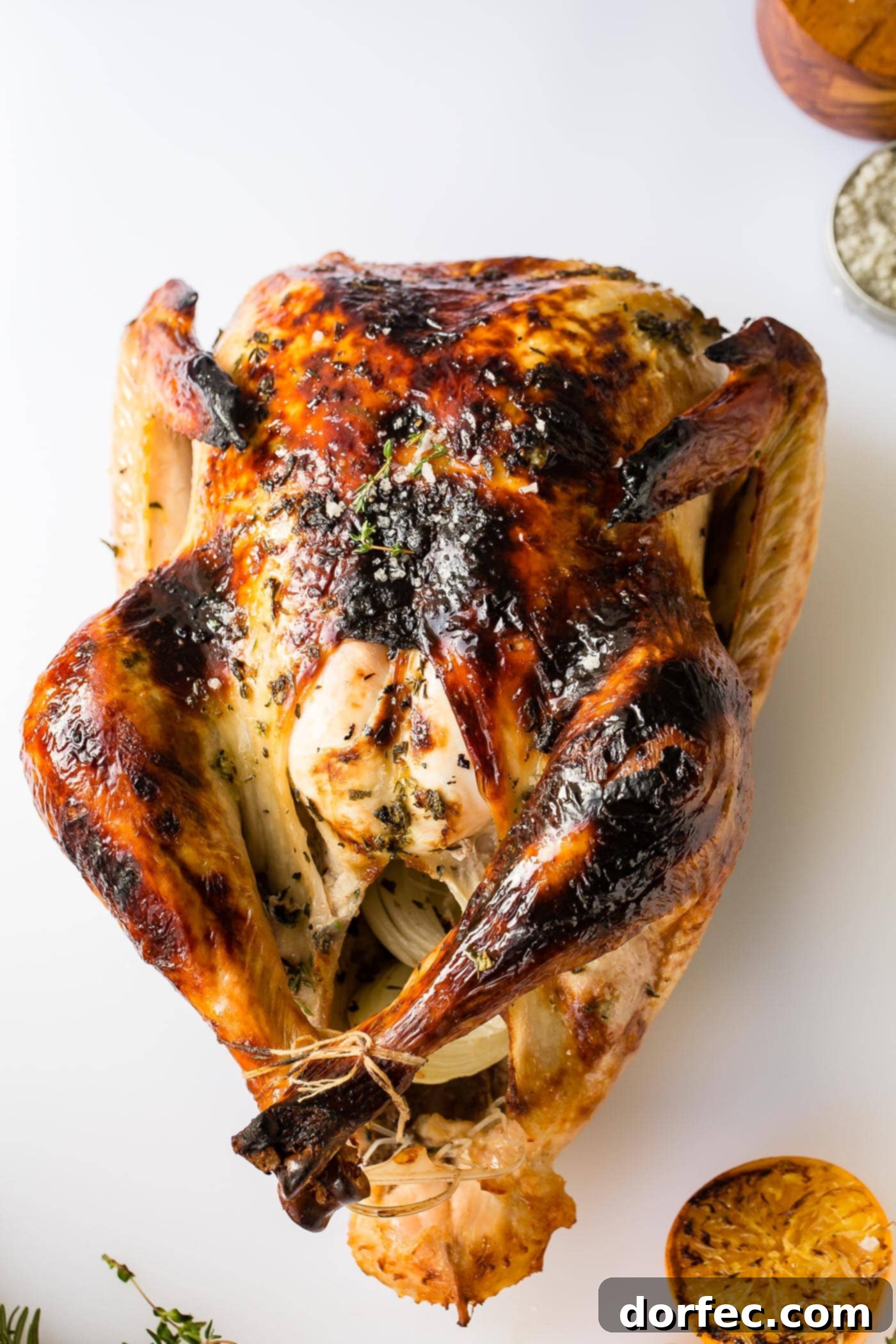 How to Carve a Turkey A beautifully roasted whole turkey, perfectly golden brown and ready for carving, resting on a large cutting board.
