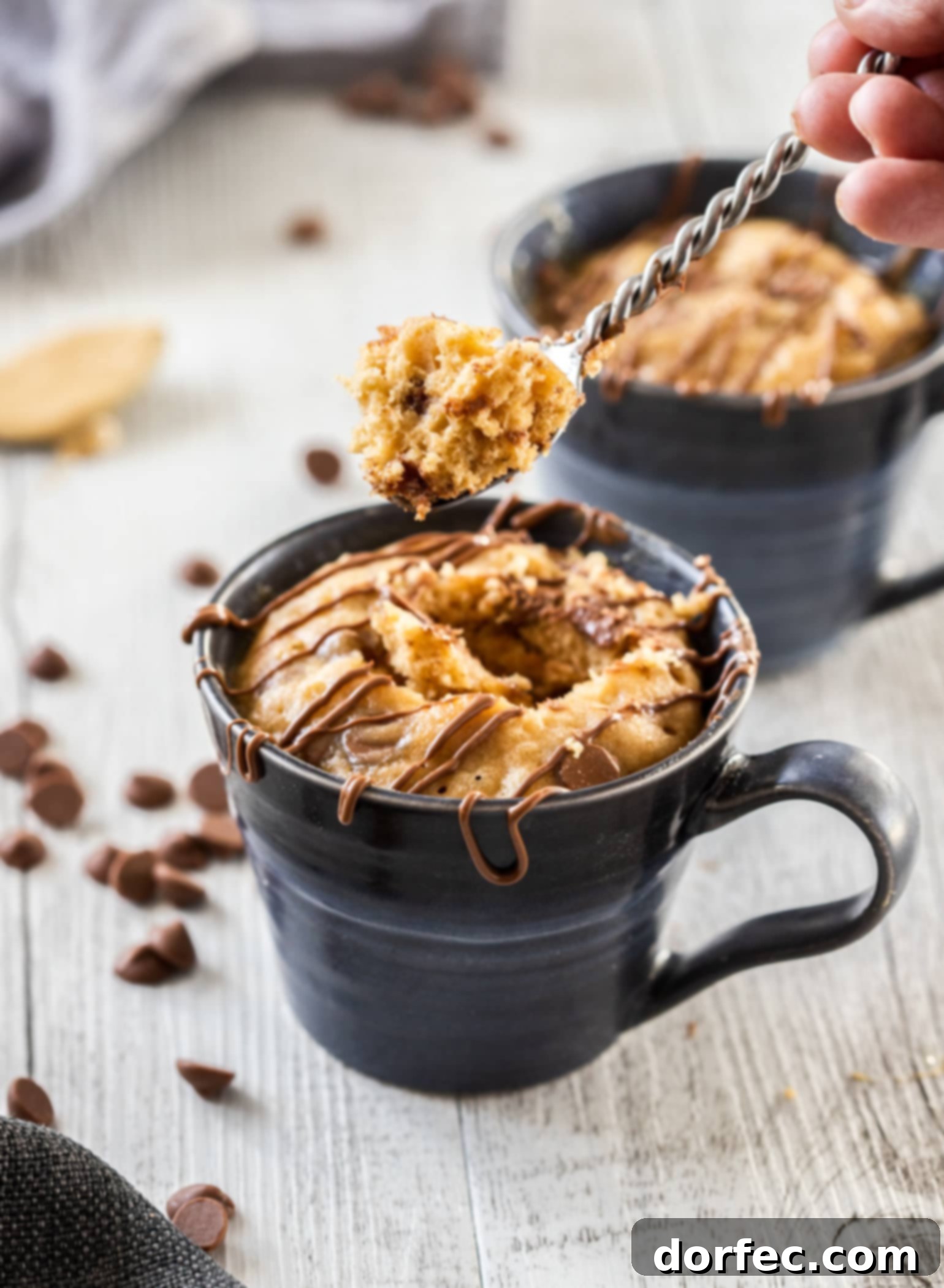 A spoon scooping cake out of a mug