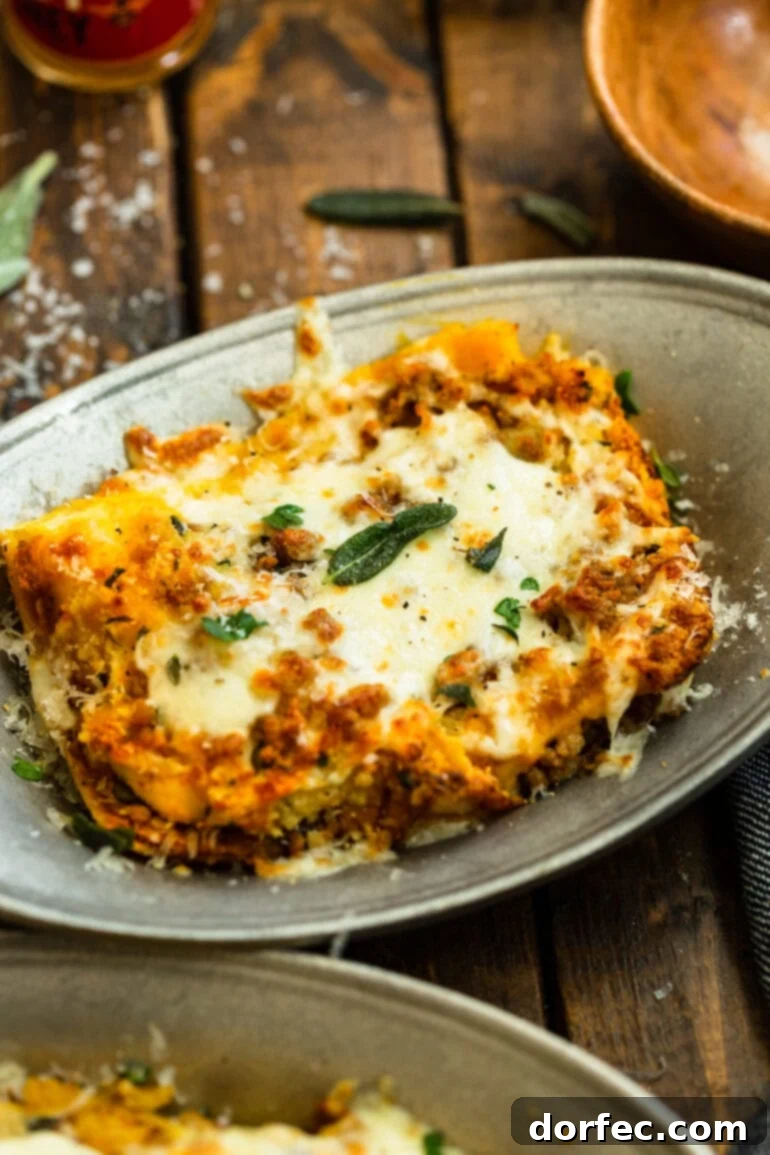 Browned Butter Pork and Butternut Squash Lasagna 6 A large serving dish overflowing with baked browned butter pork and butternut squash lasagna, topped with golden melted cheese, fresh parsley, and sage.