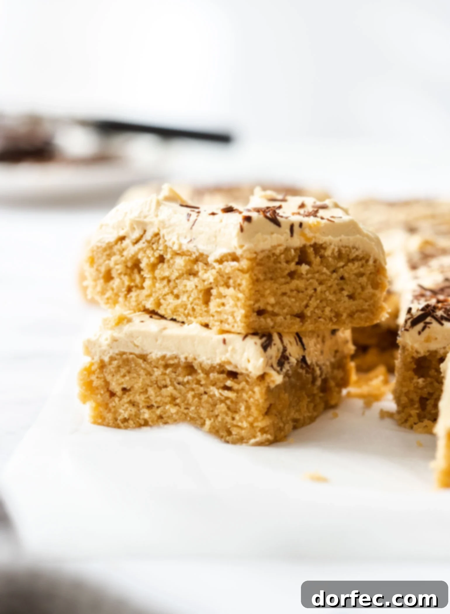 Ultimate Peanut Butter Sheet Cake 2 Two generous slices of fluffy Peanut Butter Sheet Cake, layered beautifully, promising a delightful treat for peanut butter enthusiasts.
