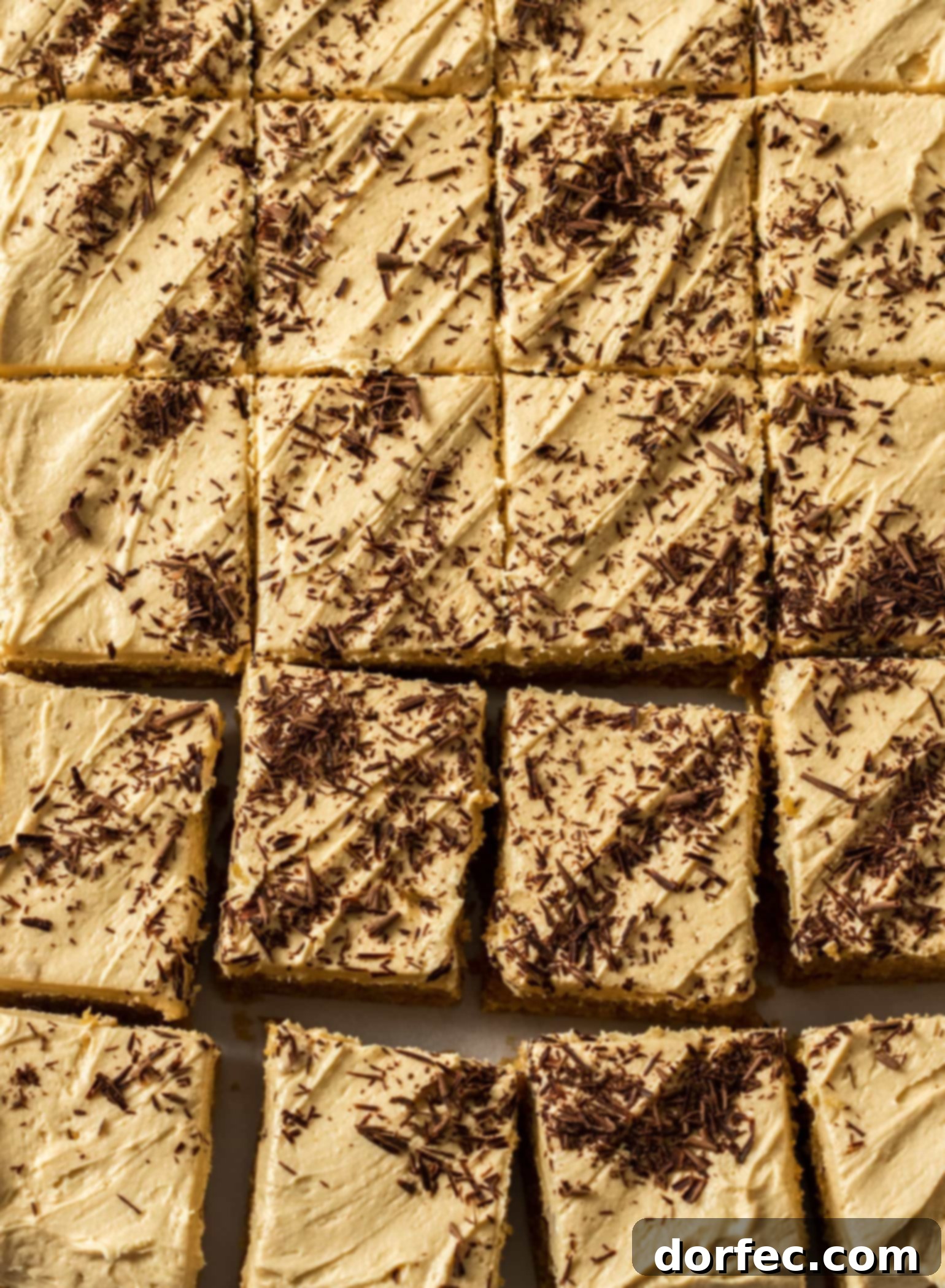 Ultimate Peanut Butter Sheet Cake 3 A close-up shot of the creamy peanut butter frosting generously spread on the sheet cake, beautifully garnished with delicate chocolate shavings, inviting a delightful bite.
