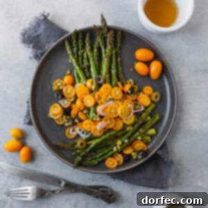 A final photo of the roasted asparagus with kumquats and olives on a serving plate.
