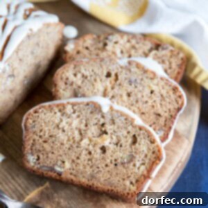 Slices of Hummingbird Cake Banana Bread on a rustic cutting board.