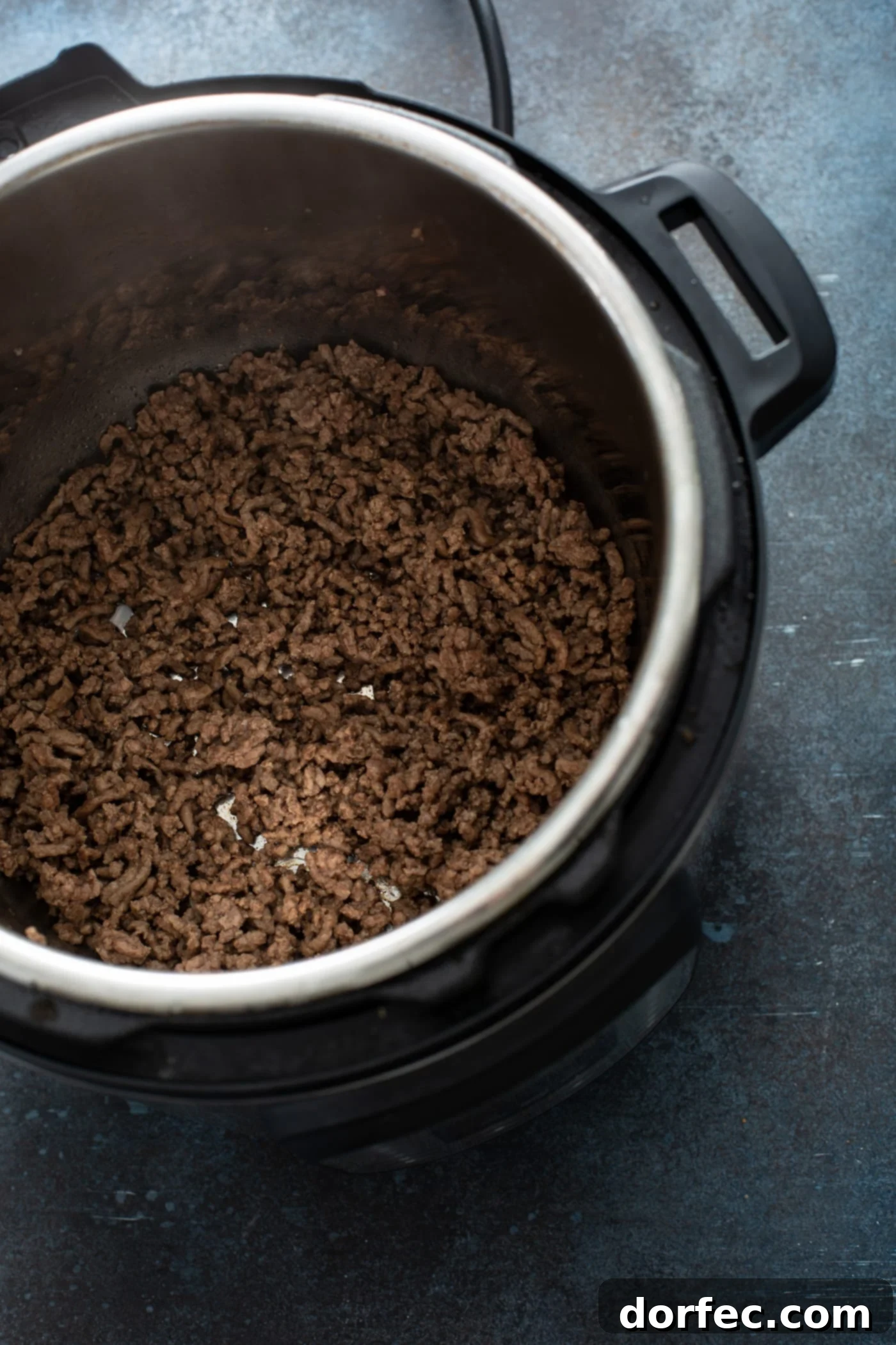 Instant Pot Sloppy Joes An instant pot containing browned ground beef.
