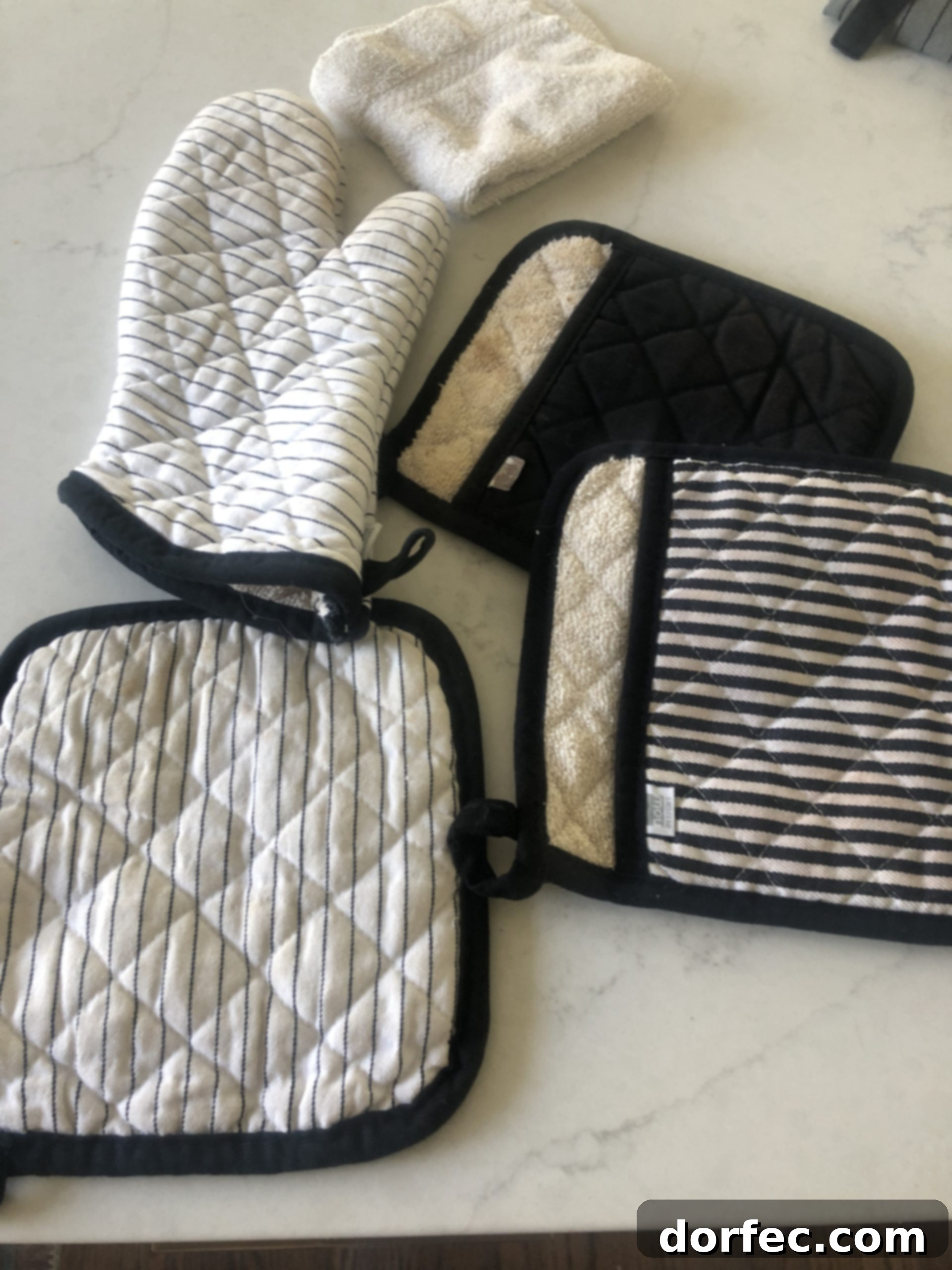 Unlock the Secret to Truly Clean Laundry 5 before and after comparison of laundry stripping on kitchen hot pads