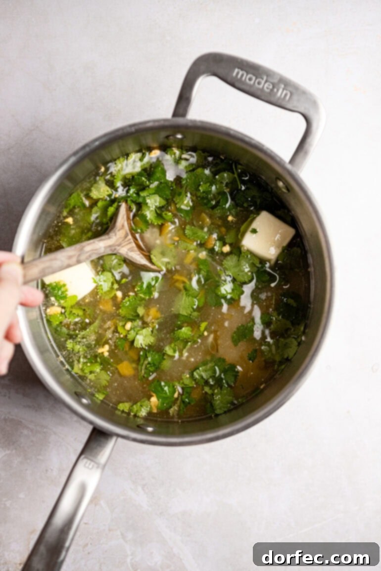 Step-by-step image of the rice simmering with the lid on.