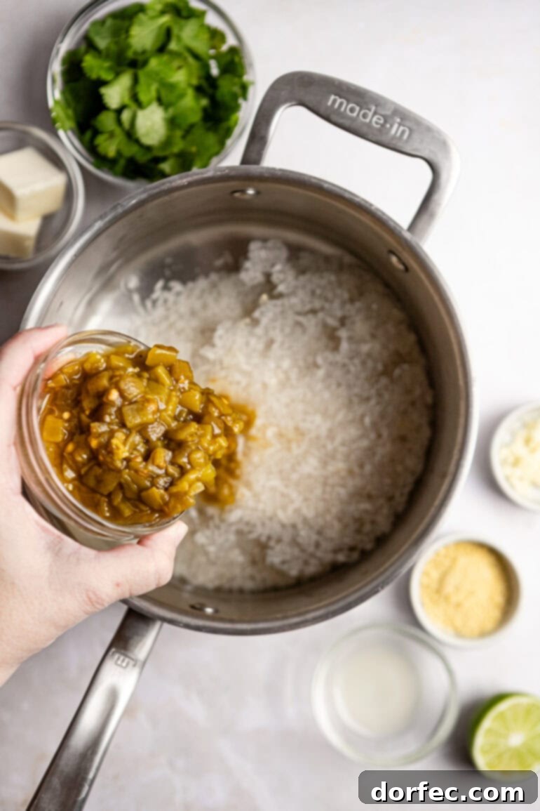 Step-by-step image of adding green chiles and garlic to the rice mixture.
