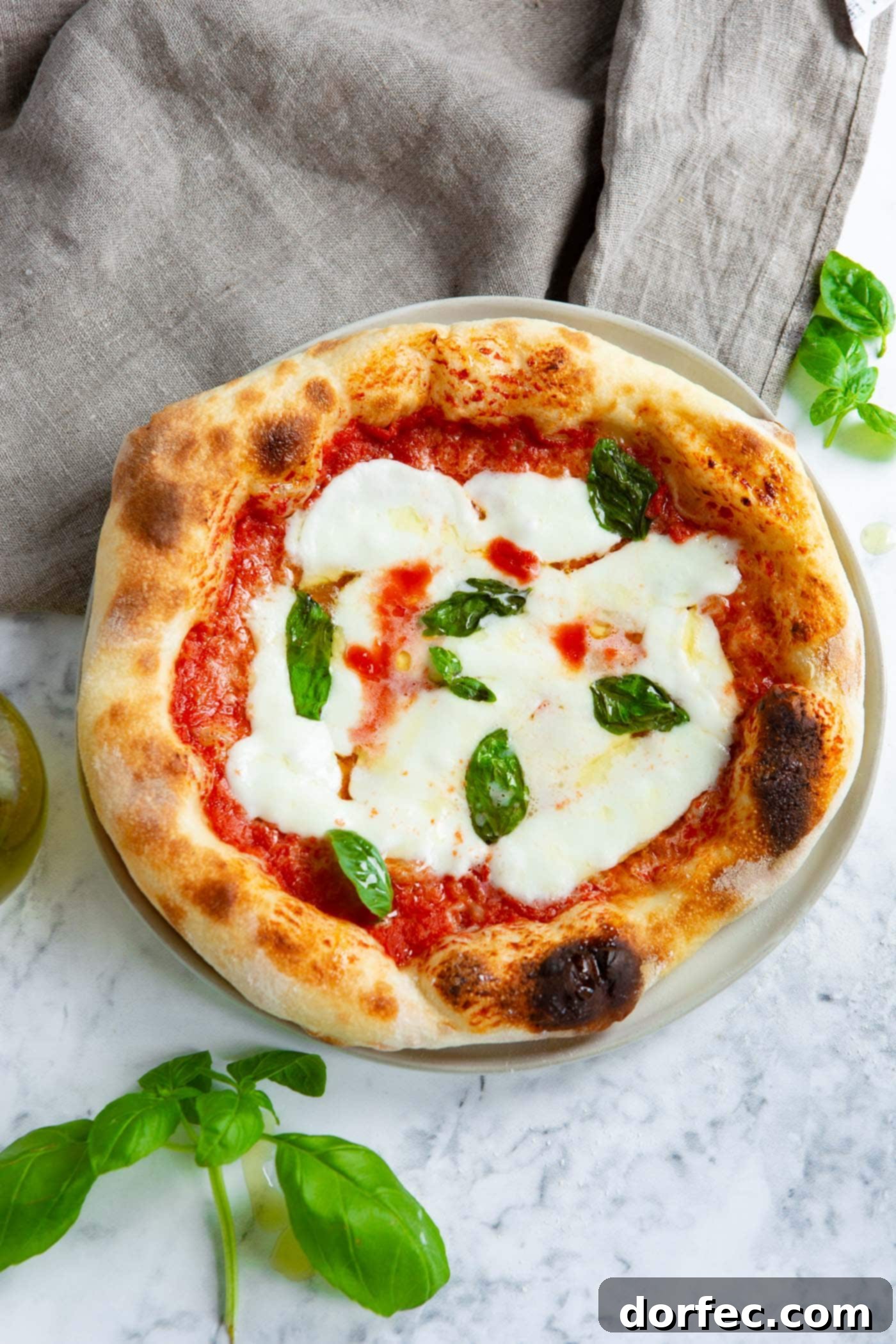 homemade margherita pizza with fresh basil leaves