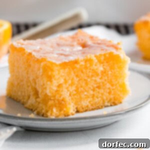 A perfectly baked Orange Jello Cake with a glossy glaze, ready for serving.