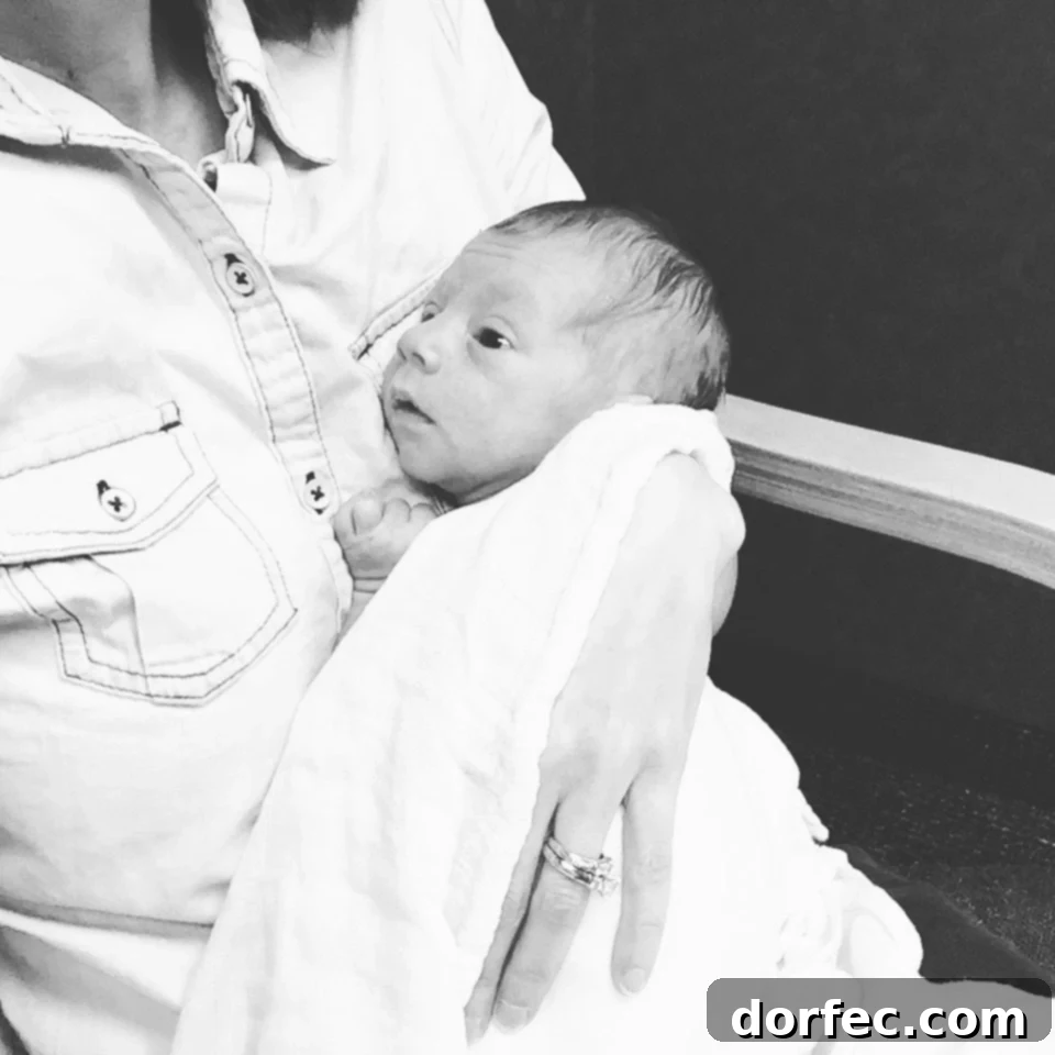 Protecting Innocence: A Mother's Journey A photo of a newborn baby wrapped in a blanket in his mother's arms, symbolizing the fragility and innocence of new life and the profound protective instinct of a mother.