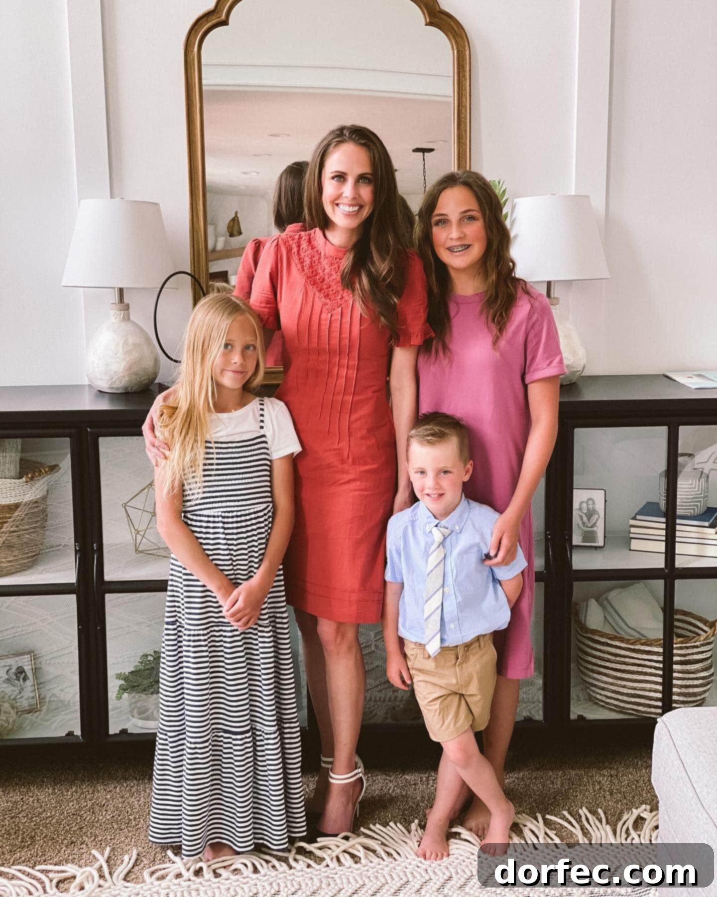 A mom surrounded by her three kids, embodying joy and maternal love.