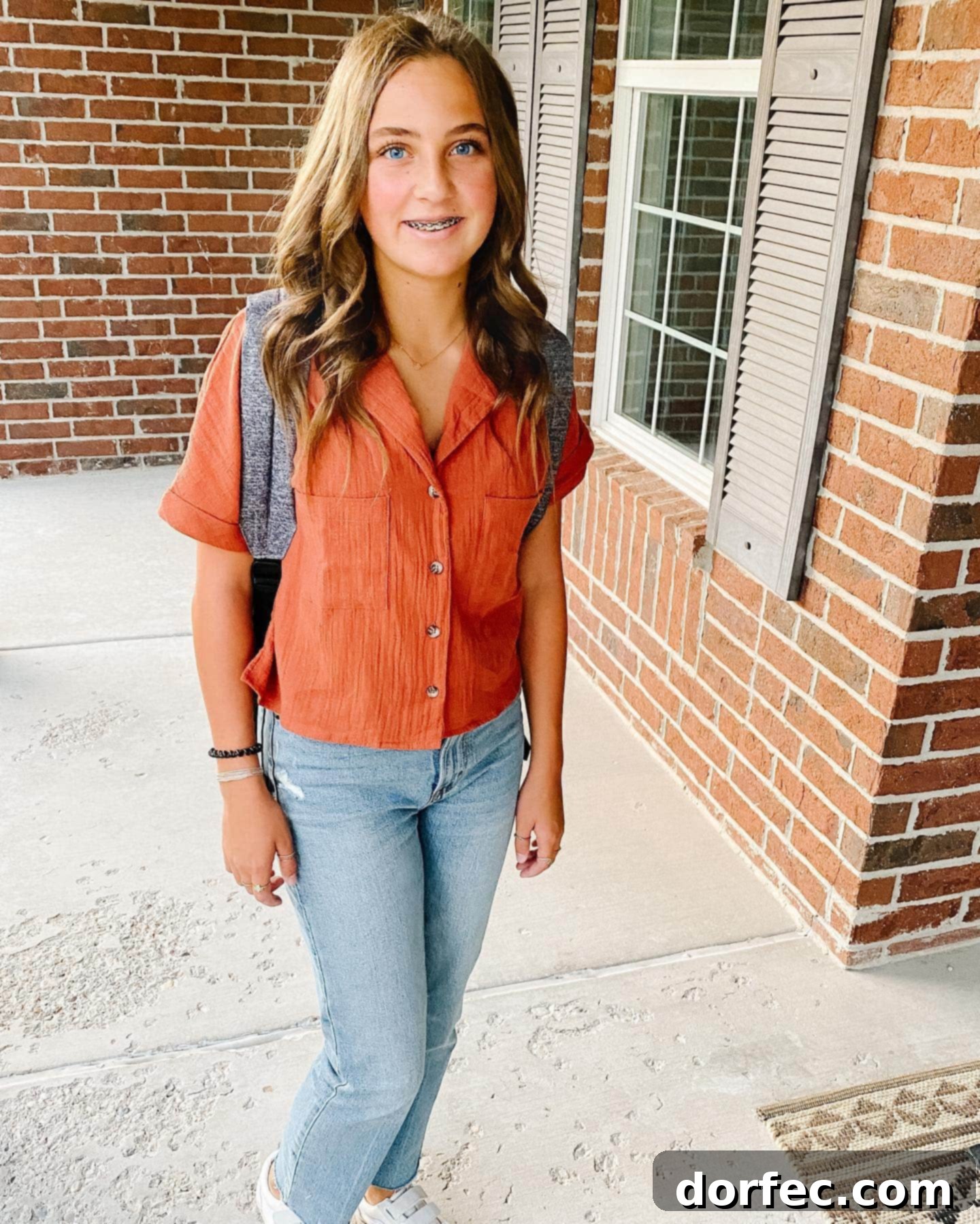 Facing the Unknown: The High School Journey A vibrant photo of a young, beautiful girl with a stylish backpack, ready for her first day of high school, embodying the excitement and slight trepidation of a new beginning and the journey ahead.