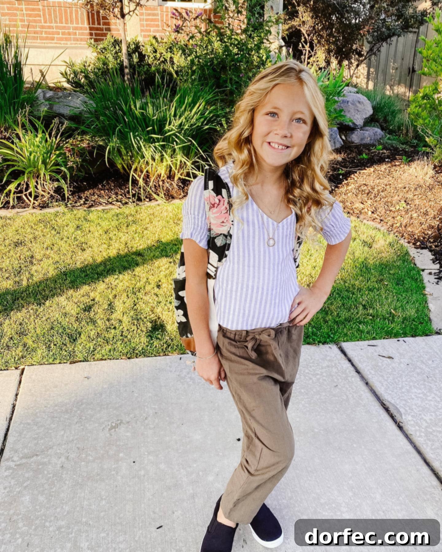 The Innocence of Elementary School A charming photo of a young girl with a colorful backpack, full of hope and ready for her first day of 5th grade, capturing the essence of childhood school beginnings and new adventures.
