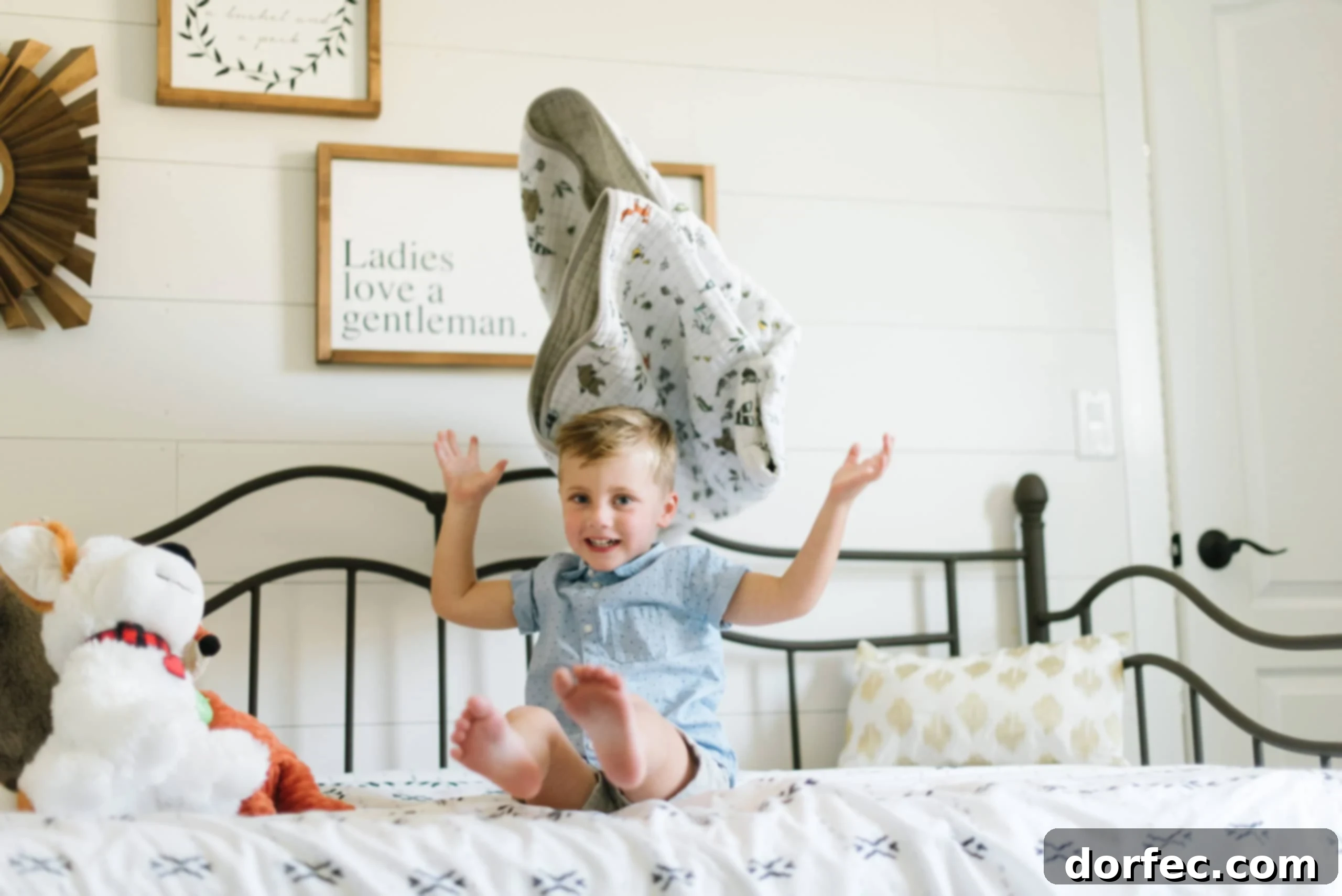 a photo of a young boy sitting on his bed throwing his blanket up in the air, a joyful expression on his face, symbolizing the lightheartedness of gratitude