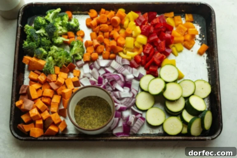 Golden Roasted Vegetable Medley 4 A sheet pan with zuchinni, carrots, sweet potato, bell pepper, onion, broccoli, and a spice blend