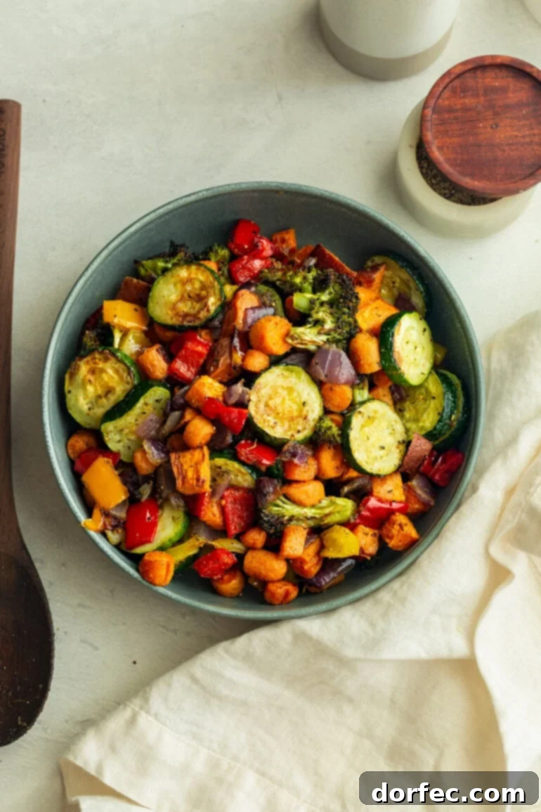 Golden Roasted Vegetable Medley 6 Blue bowl full of roasted vegetables, the golden, caramelized edges contrasting beautifully with the fresh colors.