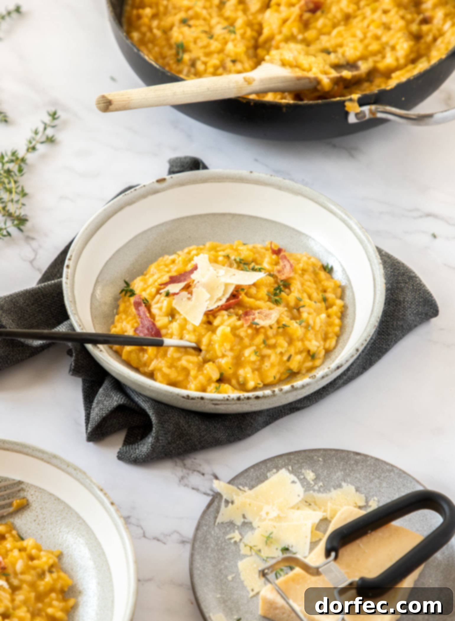 Creamy Sweet Potato Risotto 7 A grey bowl filled with creamy orange sweet potato risotto, perfectly garnished and ready to be served.