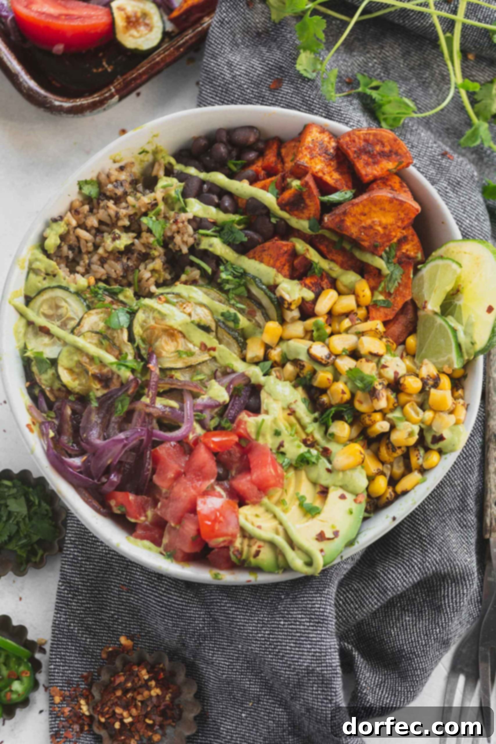 Plant Based Vegan Burrito Bowls A plant based, vegan burrito bowl filled with tomatoes, avocados, red onion, roasted corn, sweet potatoes, black beans and brown rice and quinoa.