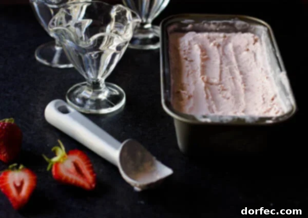 A close-up of creamy, fresh strawberry ice cream in a bowl, reminiscent of cherished family traditions and grandma's cooking.