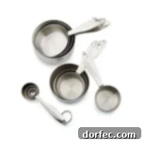 Shiny silver odd-sized measuring cups, showcasing their sturdy construction and etched measurements, a true kitchen essential.