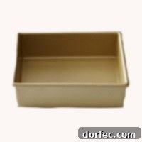 A sparkling gold square baking pan, ideal for achieving evenly baked cakes and desserts.