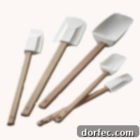 A set of five white silicone spatulas of varying sizes, indispensable for mixing, scraping, and spreading in the kitchen.