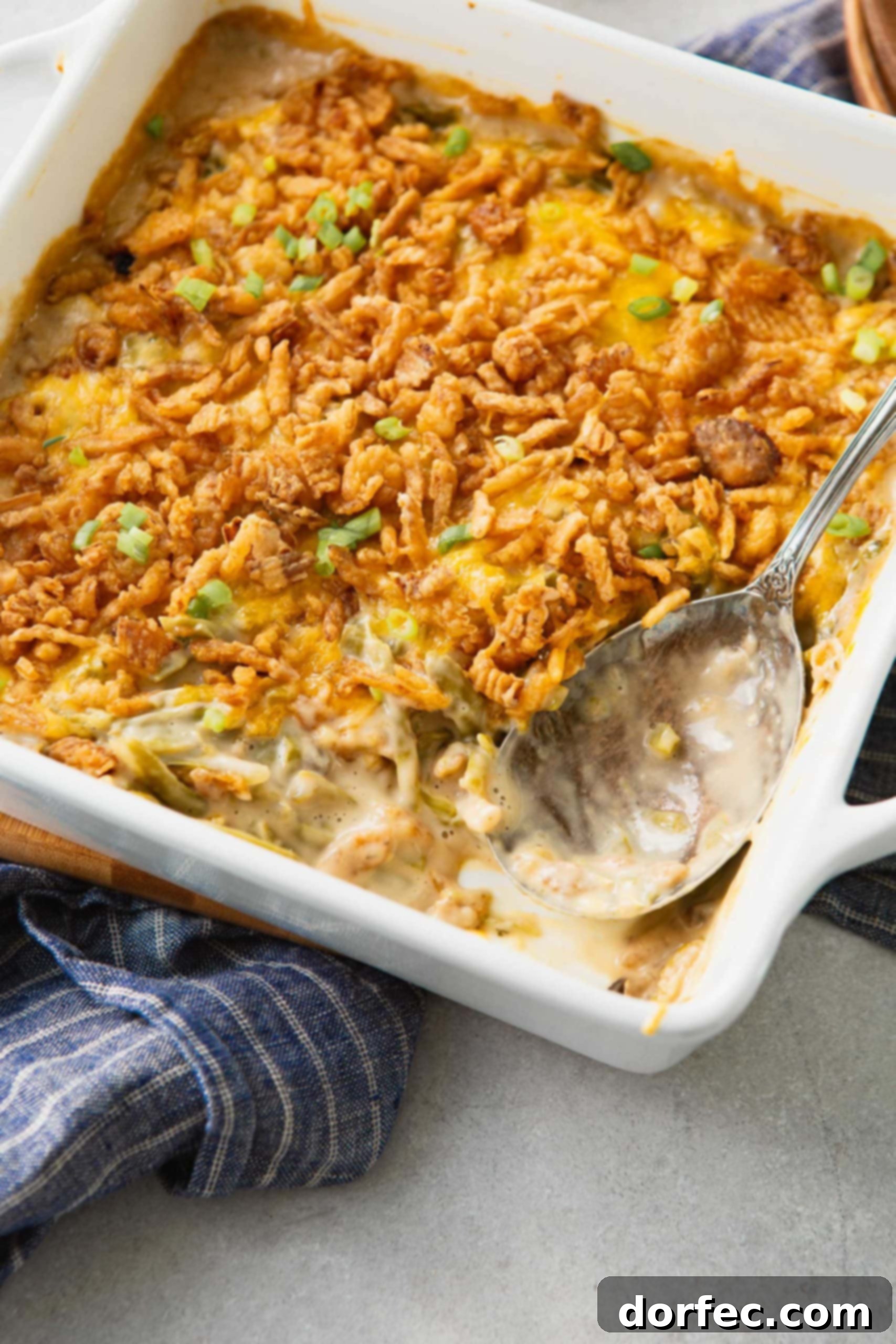 Green bean casserole that has been baked till the french fried onions on top are golden brown. You can see the green beans and sauce all mixed together with the onions on top.