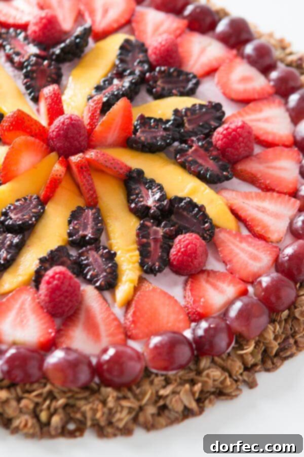 This breakfast fruit and yogurt pizza has become one of our all time favorite recipes. Easy, crunchy granola, creamy mixed berry "sauce" and fruit!