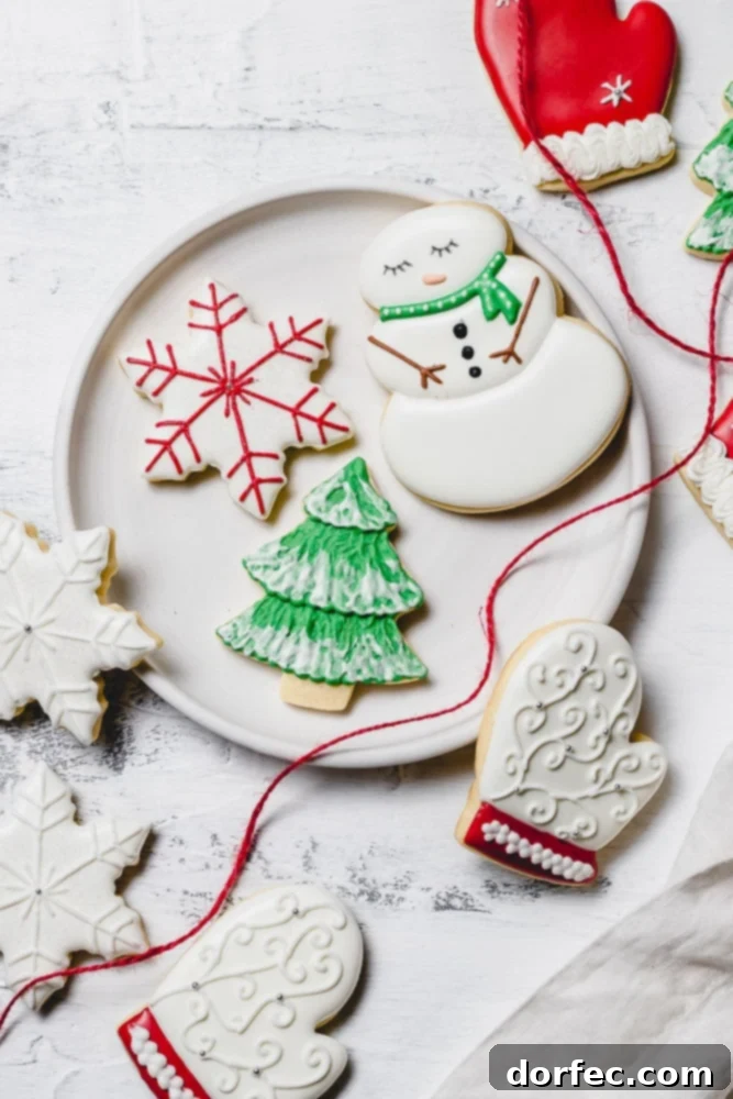 Festive Glaze for Holiday Cookies 4 A festive plate showcasing beautifully decorated Christmas sugar cookies with royal icing, including a charming snowman with a green scarf, a cozy white mitten with red trim, a vibrant green tree with snowy white accents, and a classic white star with red designs. A red ribbon elegantly drapes over the edge of the plate.
