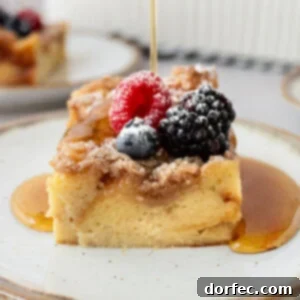 a photo of a piece of french toast casserole topped with fresh berries