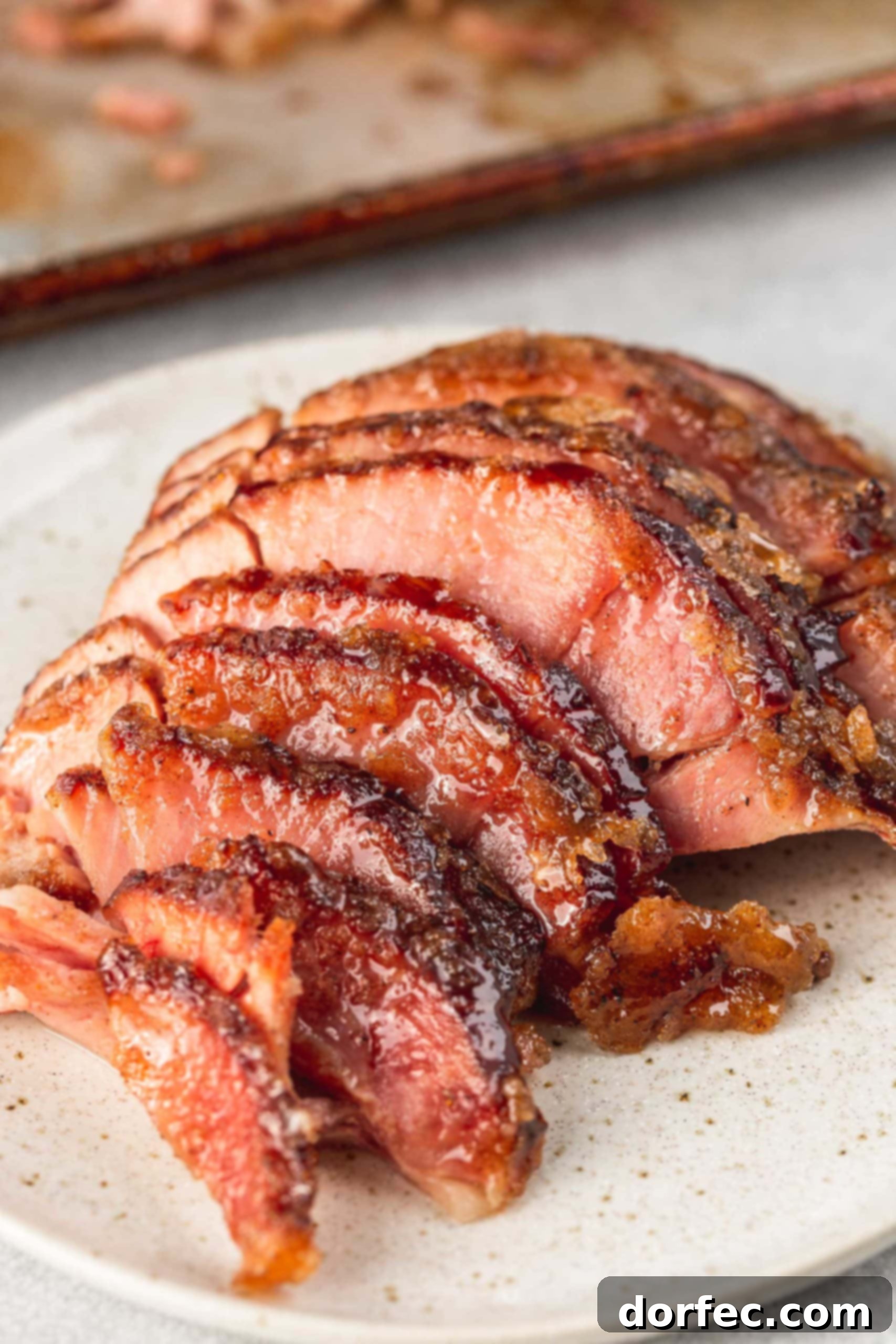 A spiral cut honey glazed ham. The slices are separated a little so you can see the juicy ham and the honey glaze.