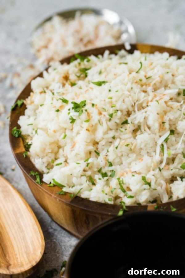 Brazilian Coconut Rice A photo of Brazilian coconut rice in a large wooden bowl and garnished with chopped fresh cilantro.