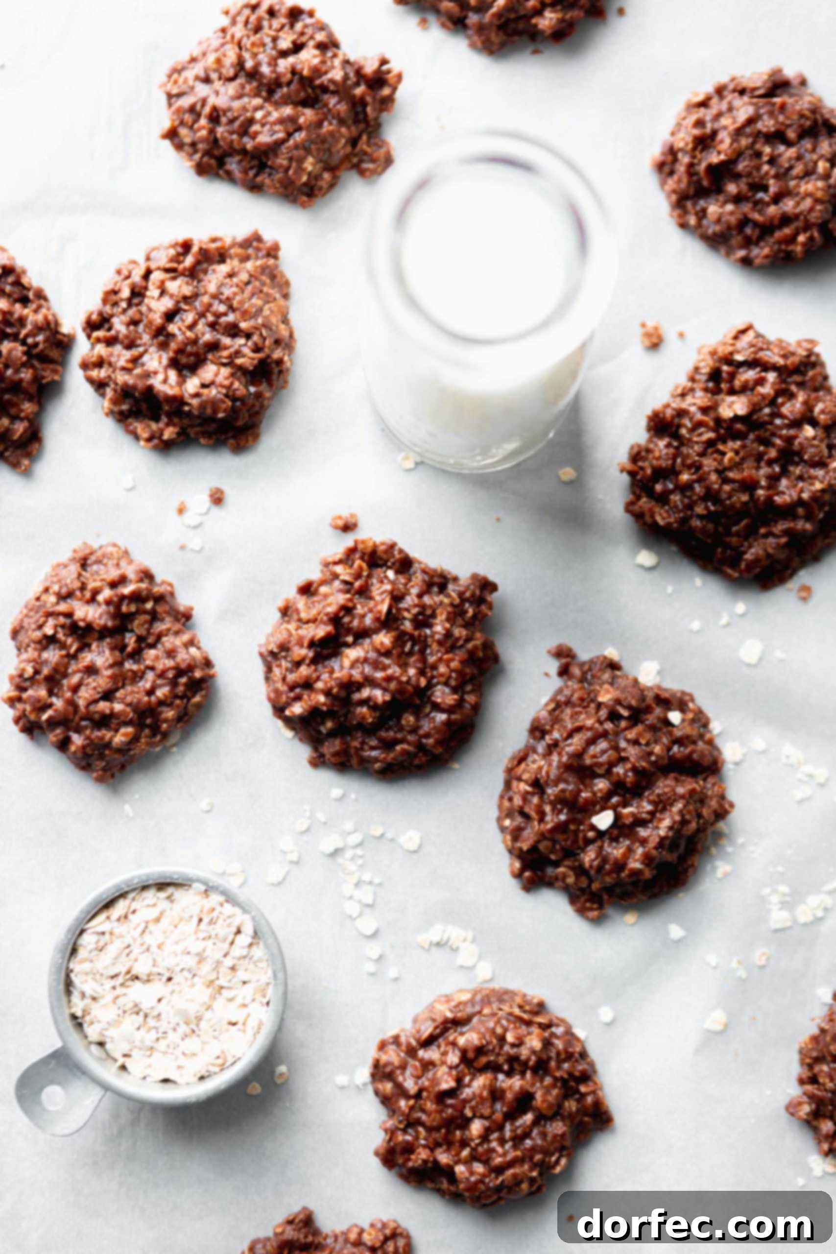 Freshly made no-bake cookies featuring oats and creamy peanut butter swirled into rich chocolate, arranged on parchment paper.