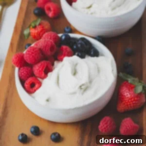 A close-up of a bowl of vanilla bean whipped cream, perfectly fluffy and creamy.