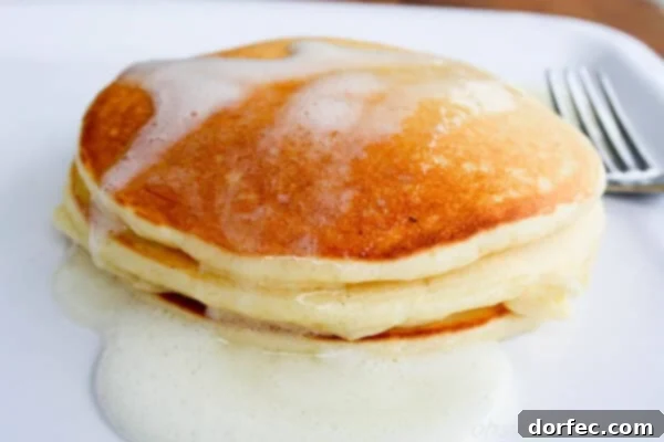 Irresistible Buttermilk Syrup 8 Meyer lemon Greek yogurt pancakes topped with fresh lemon slices and syrup.