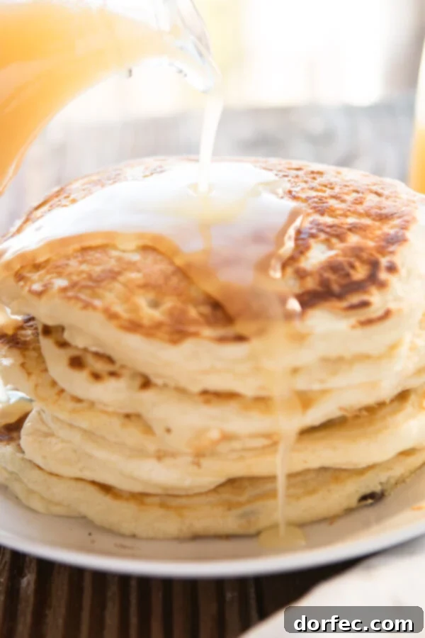 Buttermilk Syrup ohsweetbasil.com pancakes, waffles, breakfast, brunch Buttermilk Syrup drizzled over fluffy pancakes and waffles, presented for a delightful breakfast or brunch spread.