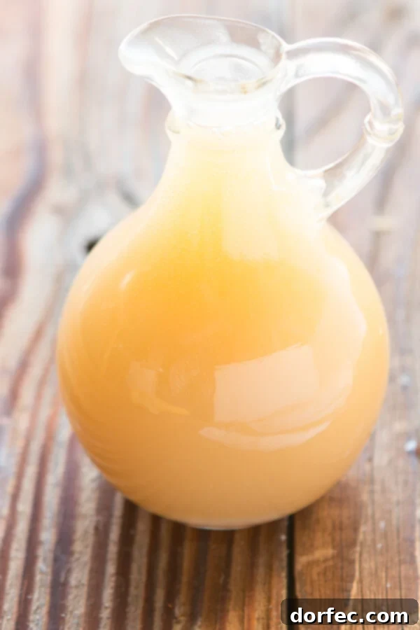Buttermilk Syrup ohsweetbasil.com pancakes, waffles, breakfast, brunch Buttermilk Syrup beautifully poured over a plate of pancakes and waffles, ready to be enjoyed for a delicious breakfast or brunch.
