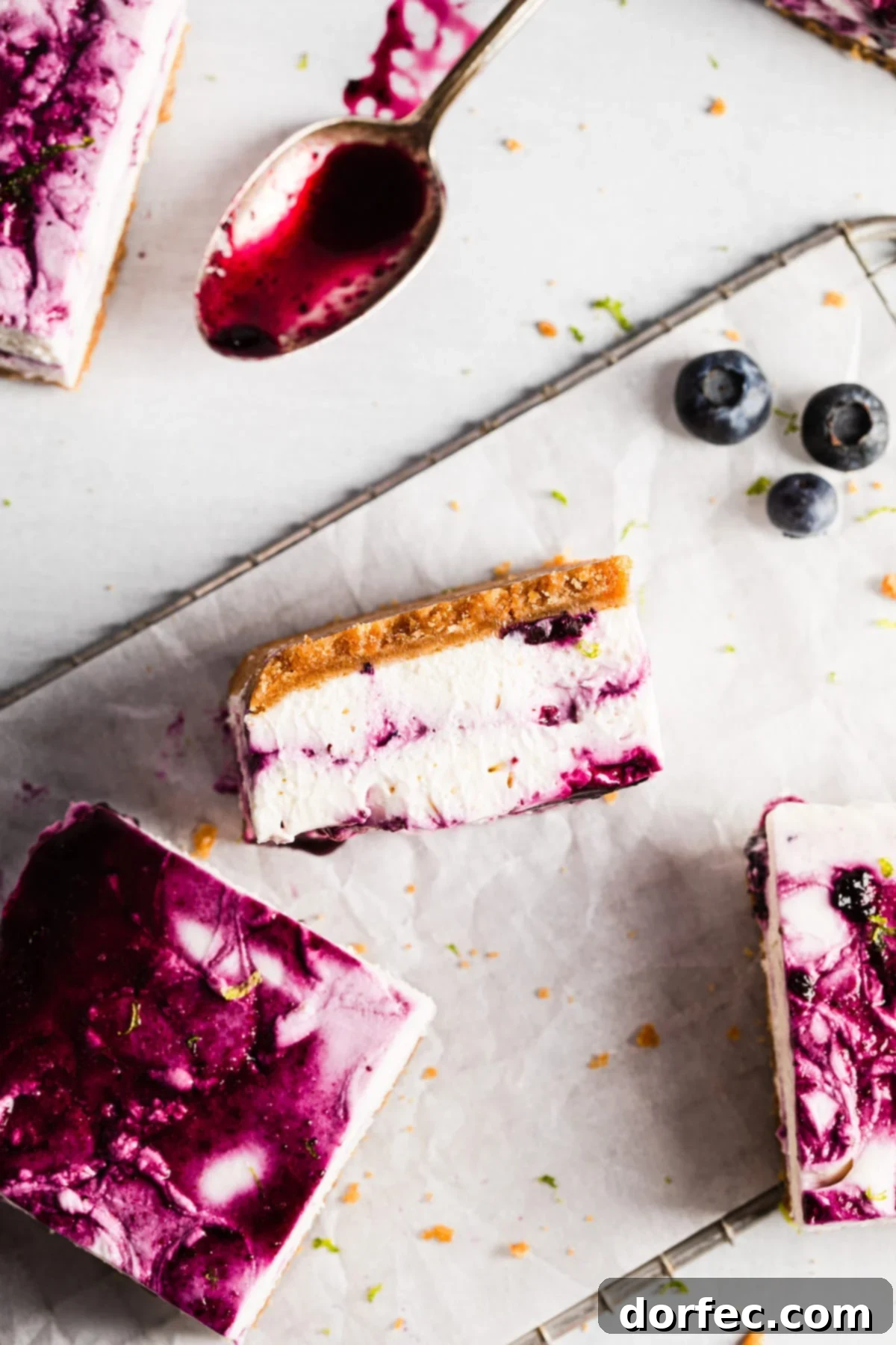 Close-up of the creamy texture and vibrant blueberry swirl in the No-Bake Blueberry Lime Cheesecake Bars