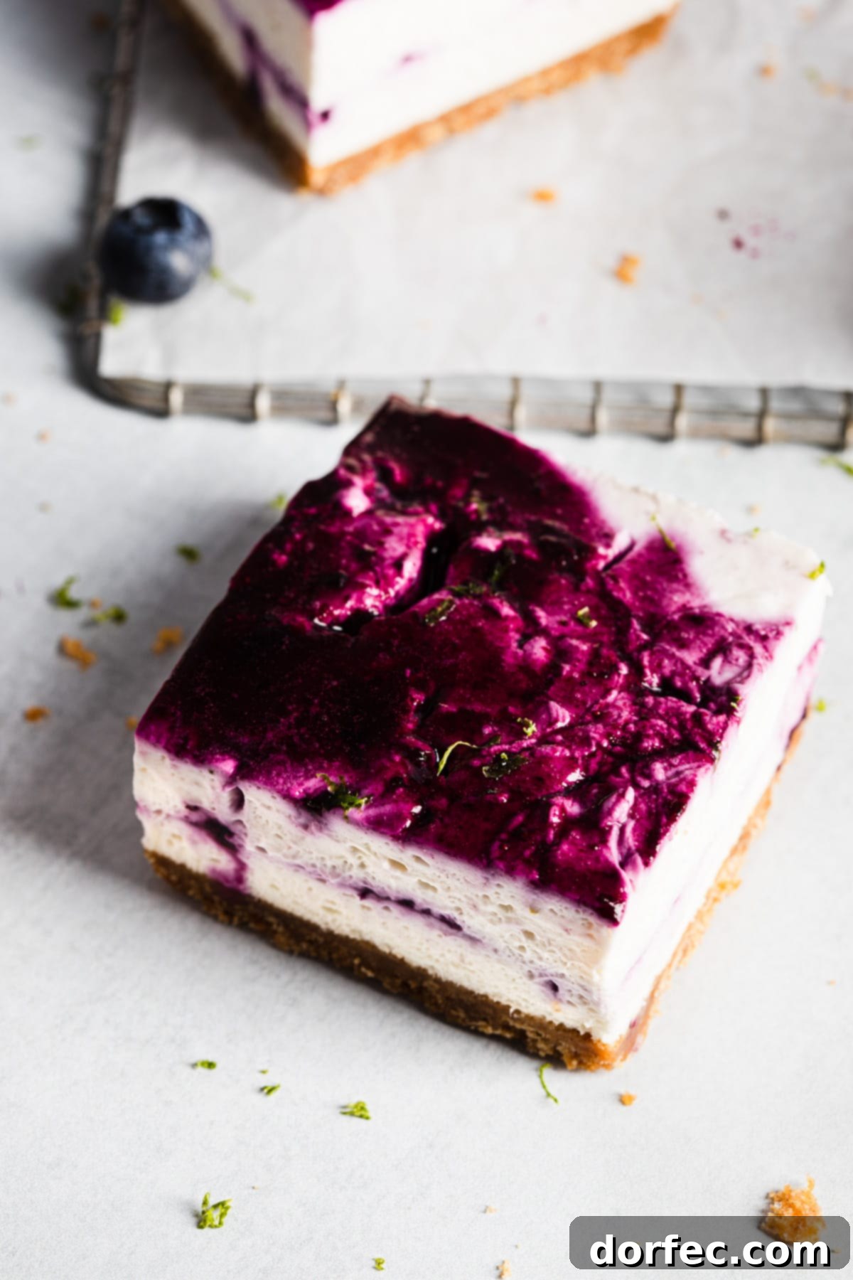 A top-down view of a single No-Bake Blueberry Lime Cheesecake Bar with a perfect swirl