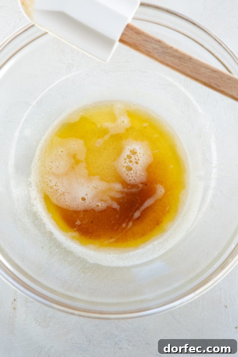 Gooey Apple Cinnamon Sticky Rolls 2 A close-up photo of melted browned butter in a glass bowl, showcasing its rich, amber hue.