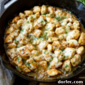 A beautifully presented One-Pan French Onion Skillet with melted cheese and fresh parsley.