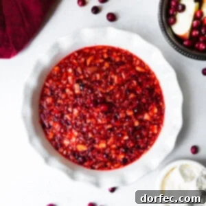 A festive white ceramic pie dish filled with Christmas Cranberry Jell-O