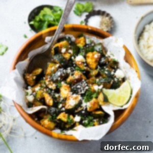 A tantalizing close-up of Mexican roasted zucchini, seasoned to perfection and garnished with fresh cilantro and cheese.